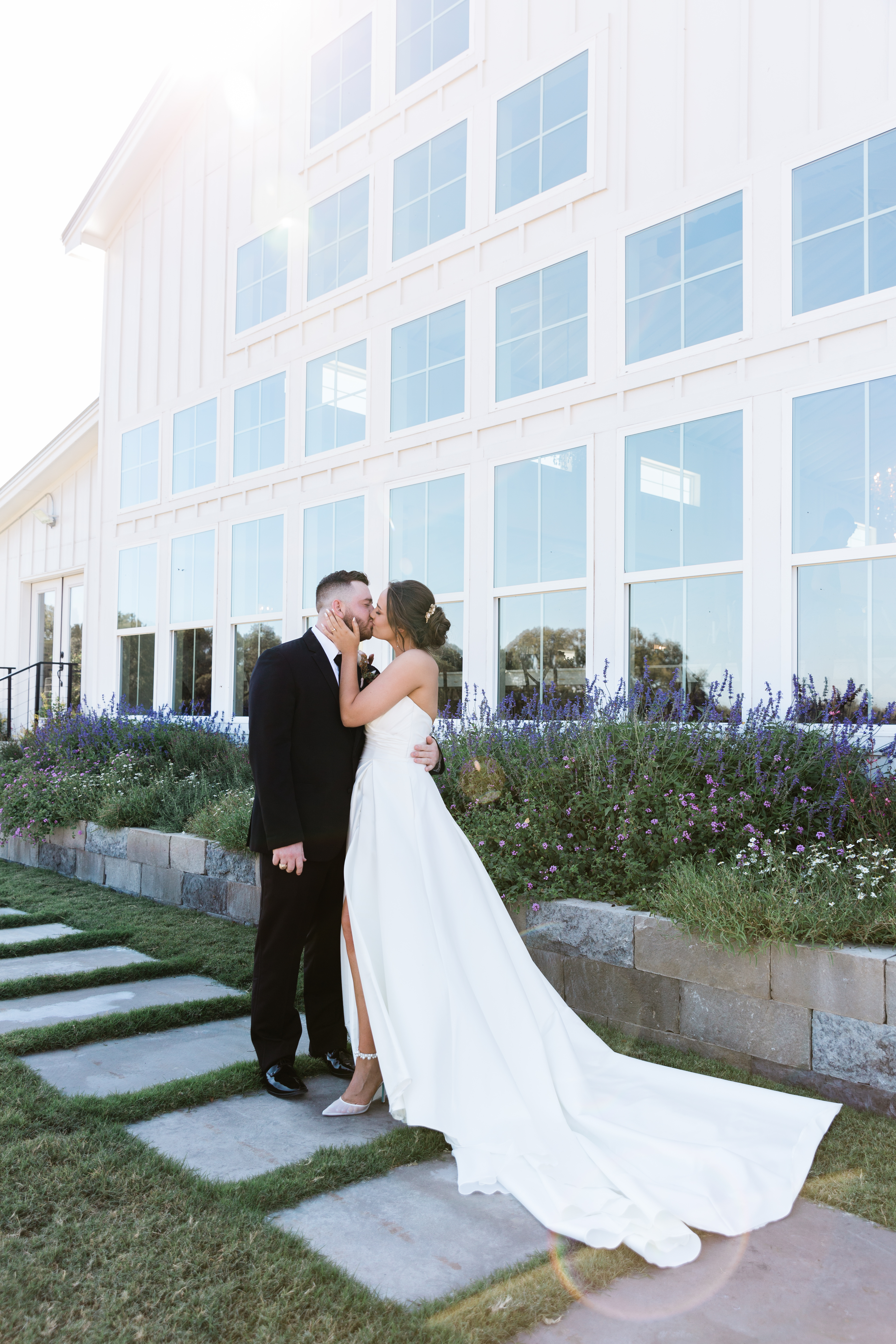 A vibrant sunset casting warm hues over the bride and groom, creating a romantic ambiance.