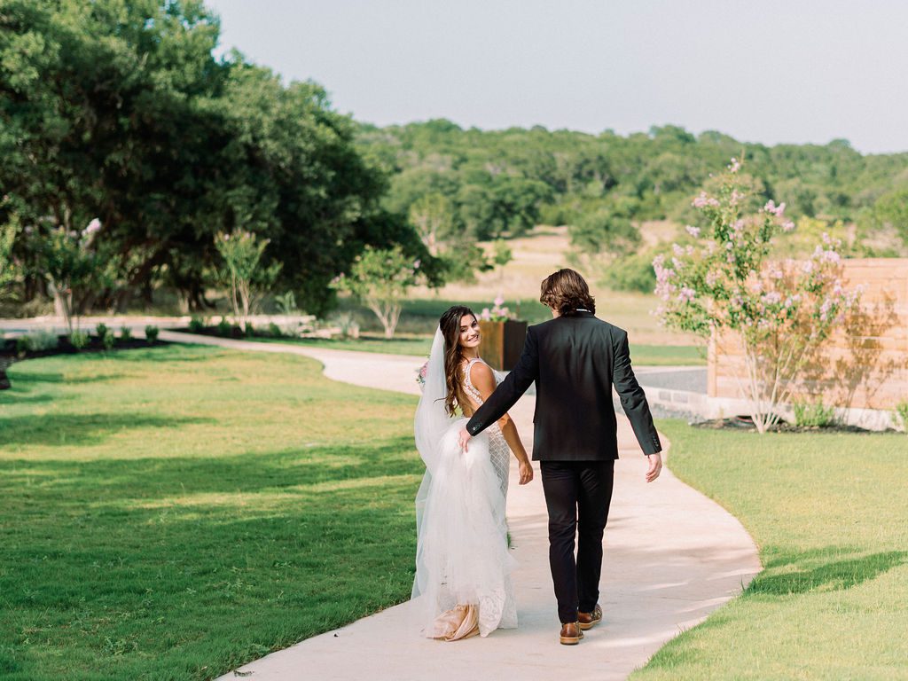 A stunning bride with a cathedral-length veil, creating a dramatic and elegant bridal look.